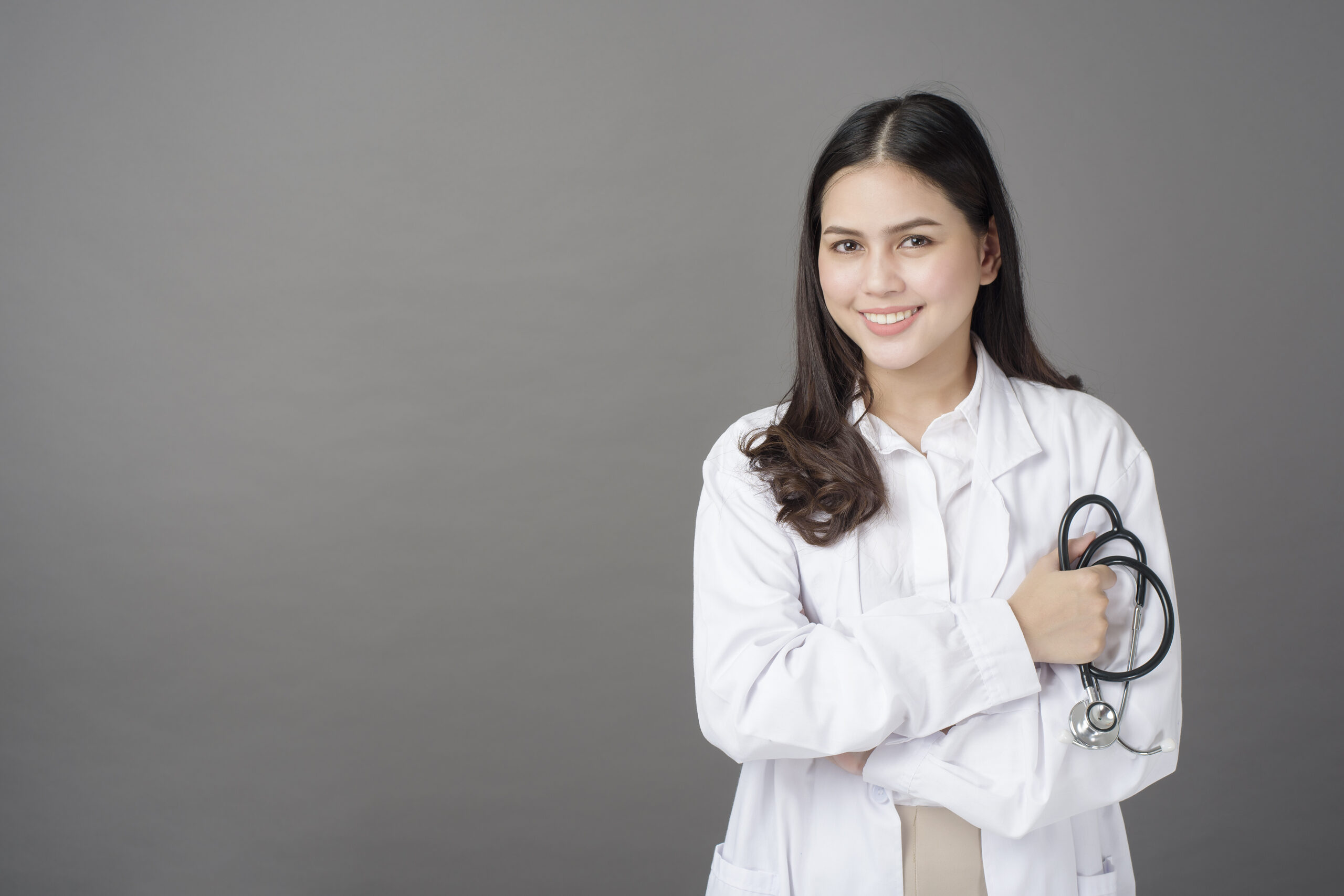 Smart woman doctor is holding stethoscope
